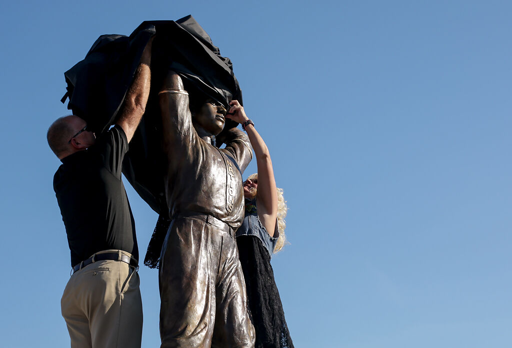 Event leaders unveil a statue of John Donaldson on Friday at Glasgow High